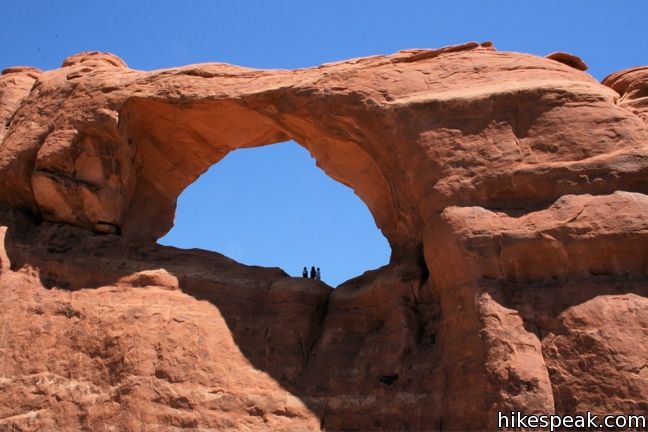 This 0.4-mile hike in Arches National Park ends below a wide arch near the top of a sandstone fin.